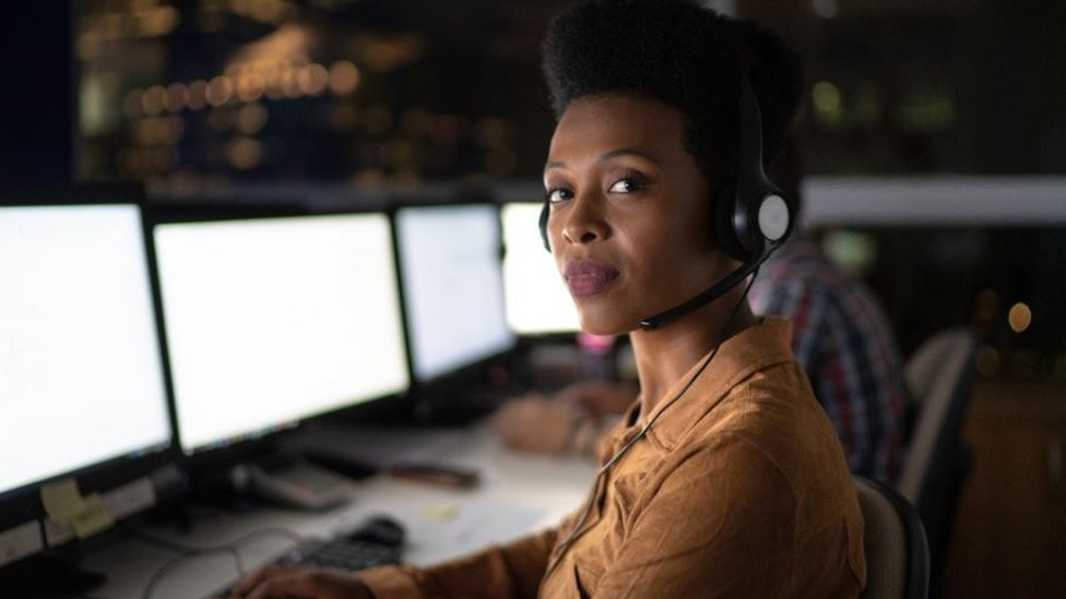 A customer service executive working in the night