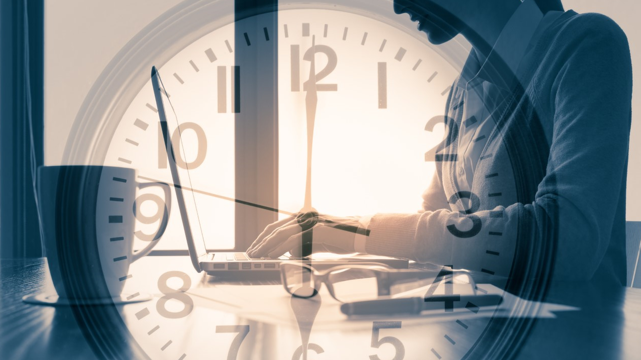 An image of a clock superimposed over a woman typing at daybreak