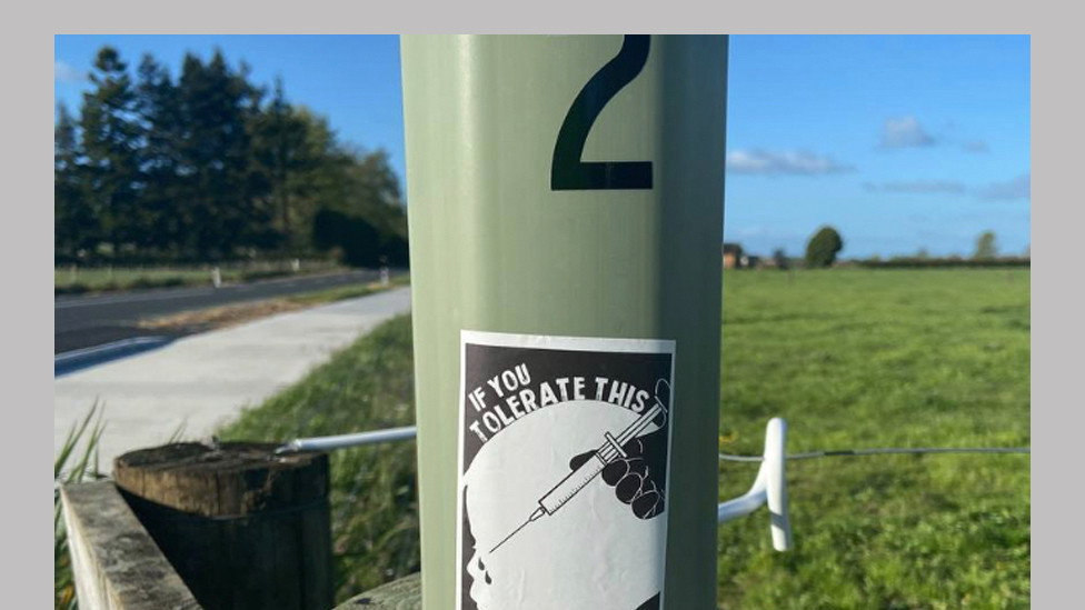 A sticker showing a child being injected and the slogan: "If you accept this then your children will be next"