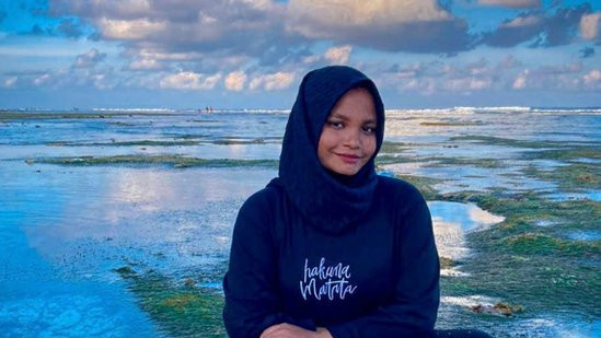 Ameera Latheef sits by the sea