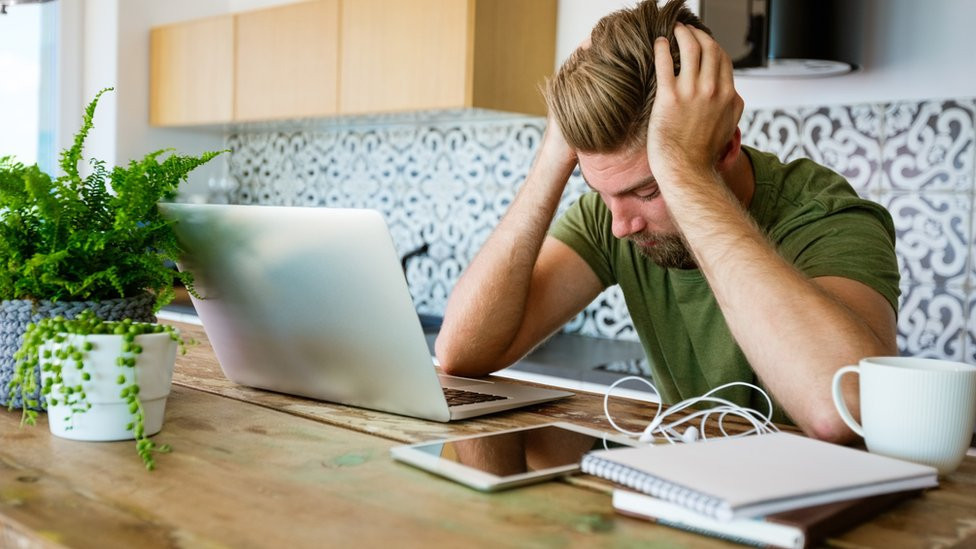 Man looking at laptop stressed