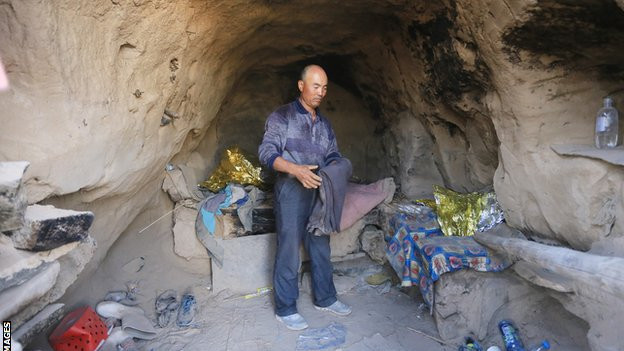 Shepherd Zhu Keming speaks to the media in a cave, where he saved the lives of runners during a mountain ultramarathon on last Saturday, on May 24, 2021 in Baiyin, Gansu province