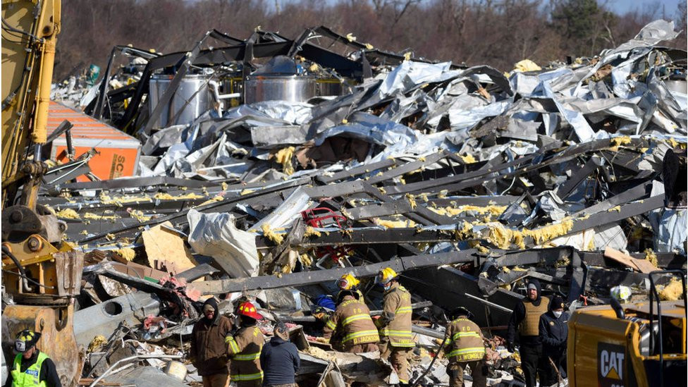 Workers search the razed Mayfield Consumer Products Candle Factory for survivors