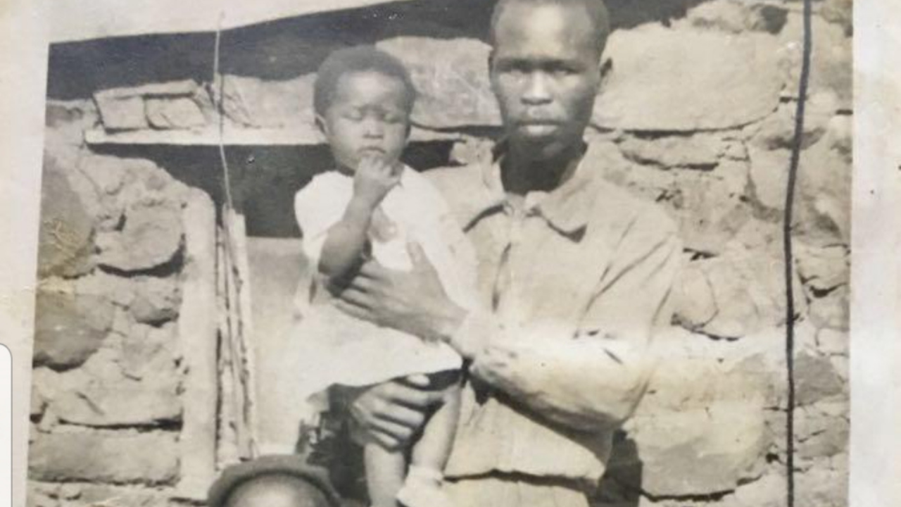A photo of Agnes Sithole with her younger sister and father outside the house she was born in