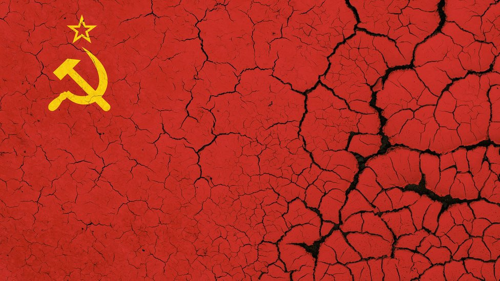 Image of the Soviet flag on parched, dry earth with cracks