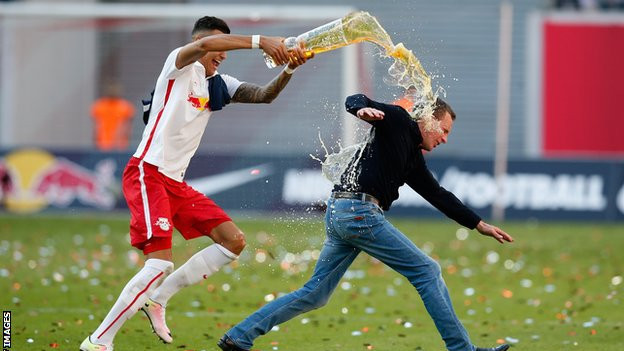 Rangnick, pictured celebrating RB Leipzig's 2016 promotion to the Bundesliga, chased by a player pouring beer over his head