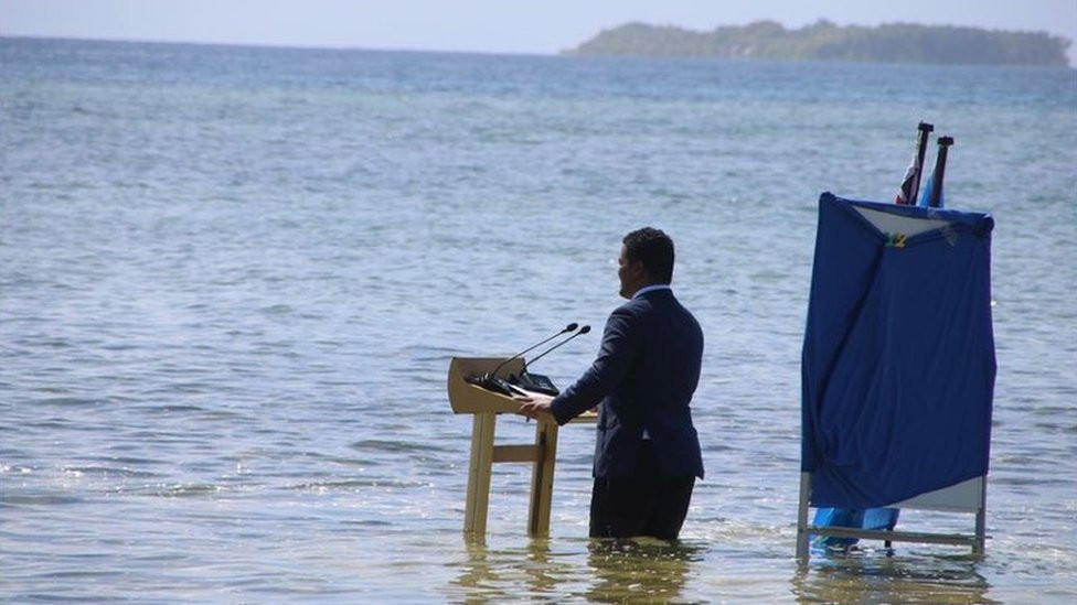 Man in suit submerged in water