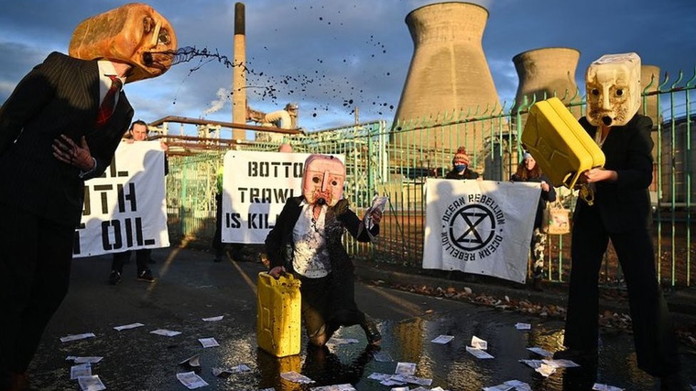 Protesters wearing oil jugs as masks and pouring petrol outside gates