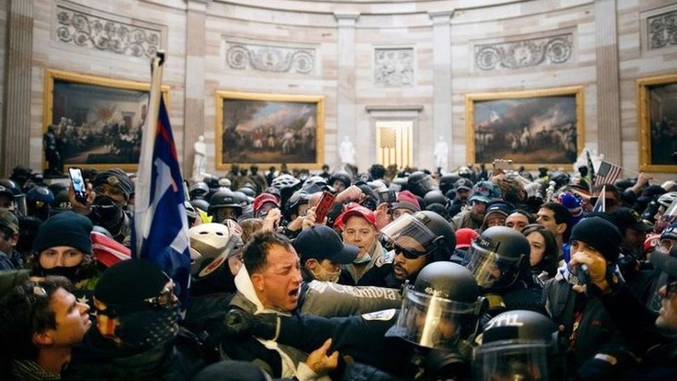 Crowds with flags inside the US Capitol building