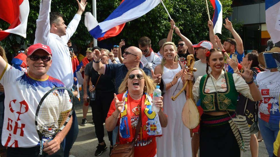 People celebrate after Australian court quashes visa cancellation for Novak Djokovic on 10 January 2022 in Melbourne, Australia