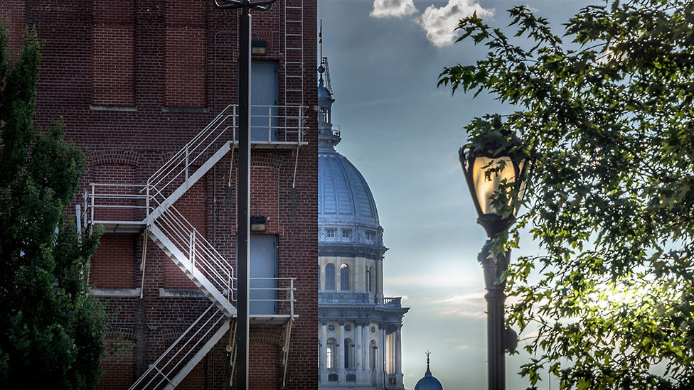 The Capitol building and a red brick building seen in Springfield, Illinois, USA