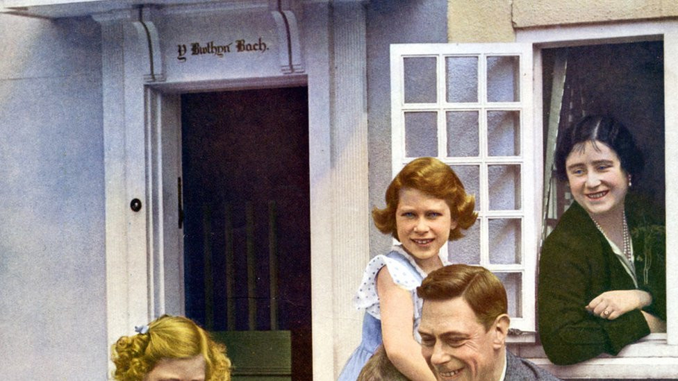 Elizabeth and Margaret with their parents and dogs at Windsor in 1936