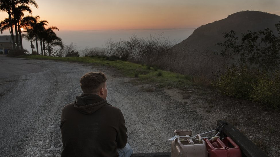 Kase Dietrich sits on the tailgate of Brayden's 91 Chevy pickup, near Oceanside, LA