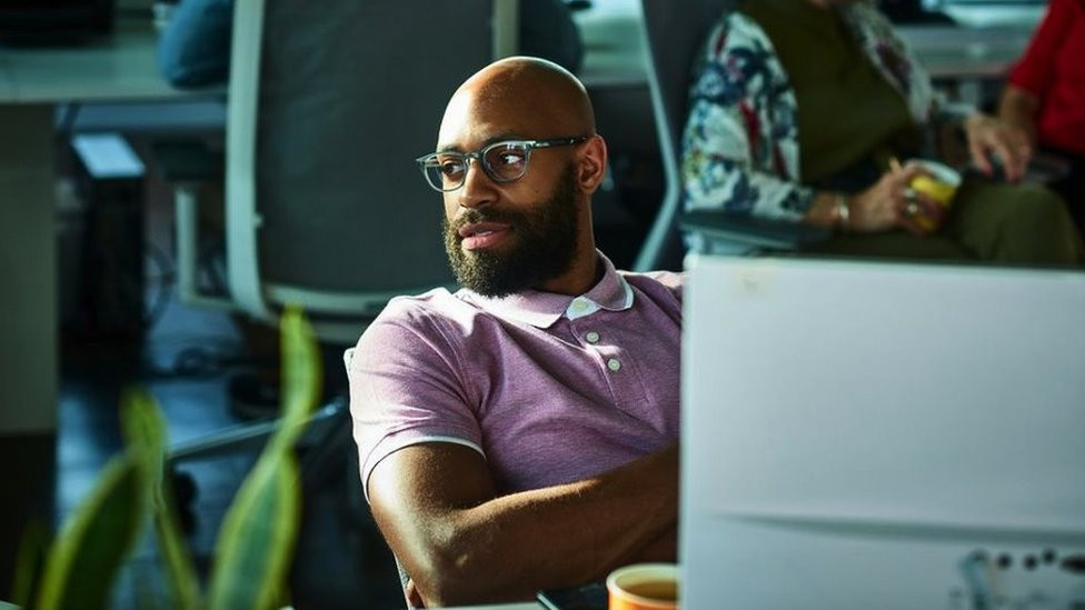 Male worker looking away from desk