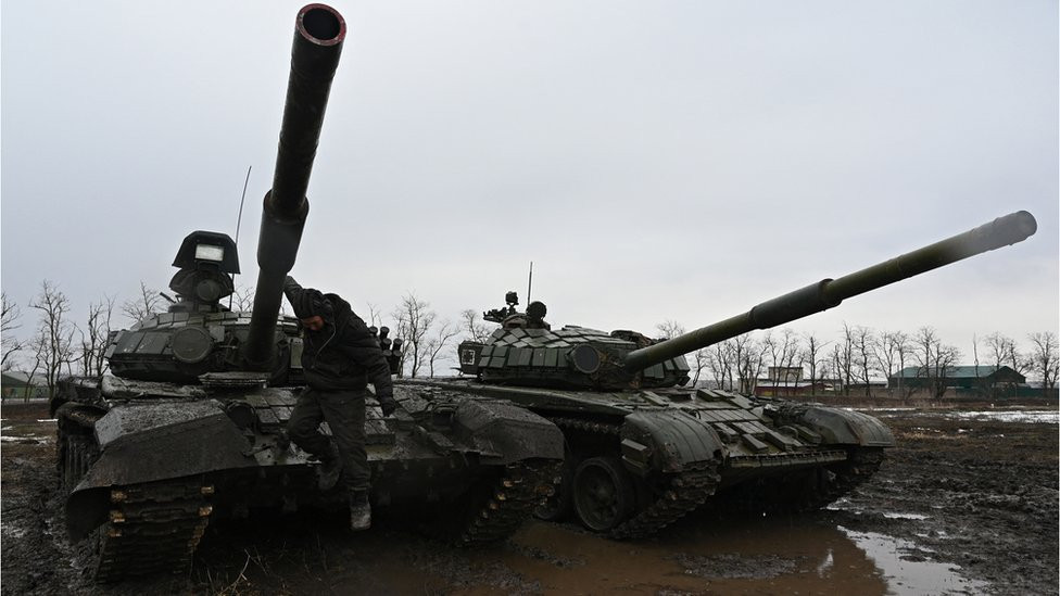 A Russian service member jumps off a T-72B3 main battle tank during drills held by the armed forces of the Southern Military District at the Kadamovsky range in the Rostov region, Russia