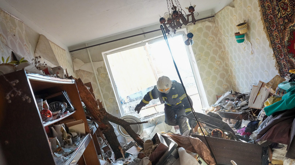 Ukrainian firefighters arrive to rescue civilians after an airstrike hit an apartment complex in Chuhuiv, Kharkiv Oblast, Ukraine on 24 February 2022