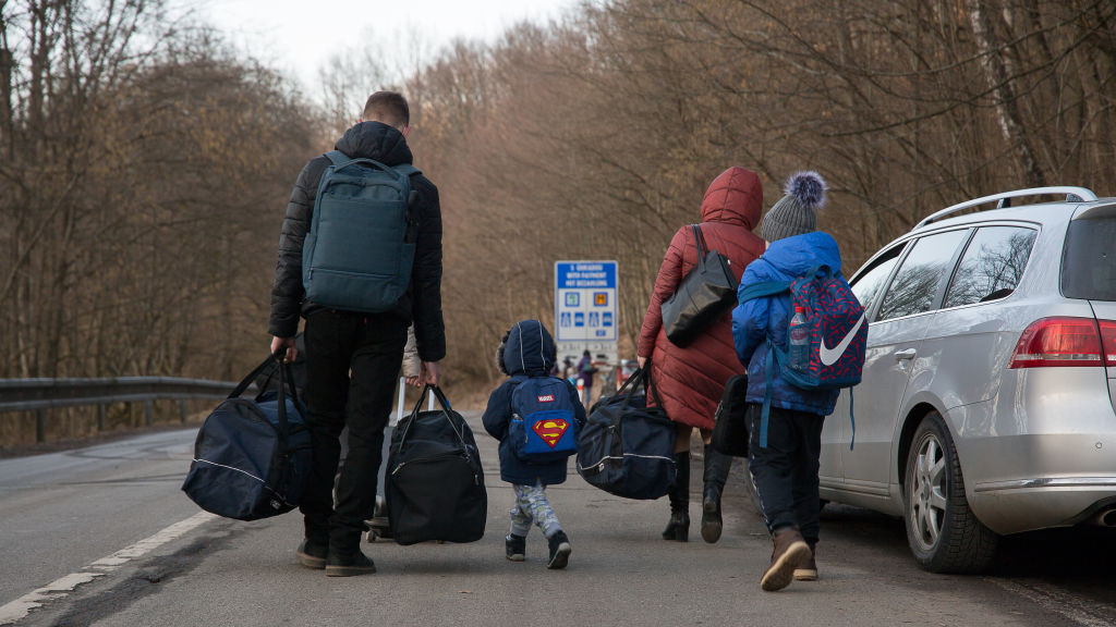 Ukrainians walking across the border into Slovakia