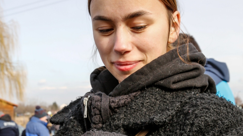 A young Ukrainian woman with her cat, crossing into Poland
