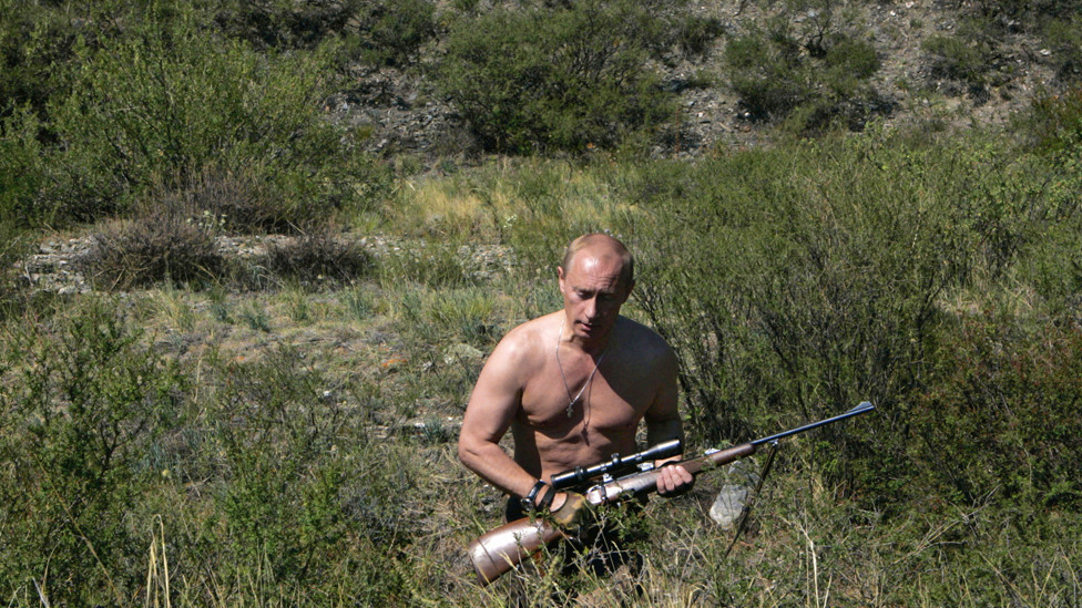 Russian President Vladimir Putin carrying a hunting rifle in the Republic of Tuva, 15 August 2007.