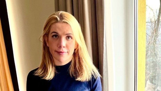 Kira Rudik holding a gun