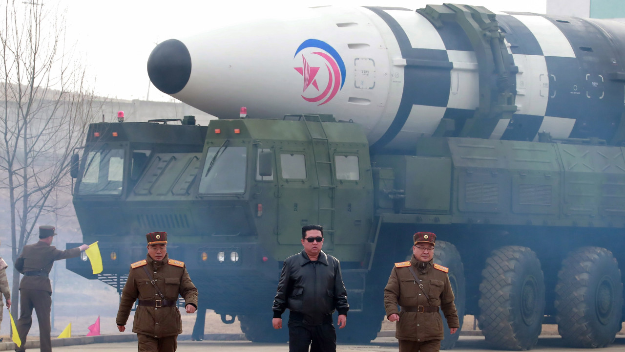 Photo released by the official North Korean Central News Agency (KCNA) shows Kim Jong Un (C), Jang Chang-ha (L rear), Chief of the Academy of National Defense, and Kim Jong-sik (R), the Deputy Director of the Munitions Industry Department, during the test-launch of a new type of inter-continental ballistic missile Hwasongpho-17 of the DPRK strategic forces that was conducted on 24 March 2022