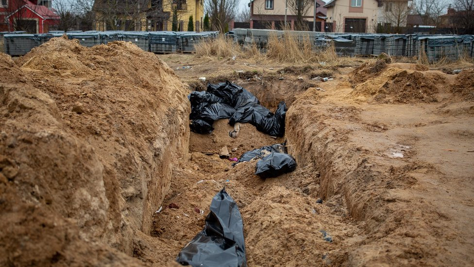 A mass gave on the grounds of a church in Bucha, where bodies were discovered when the Russians retreated