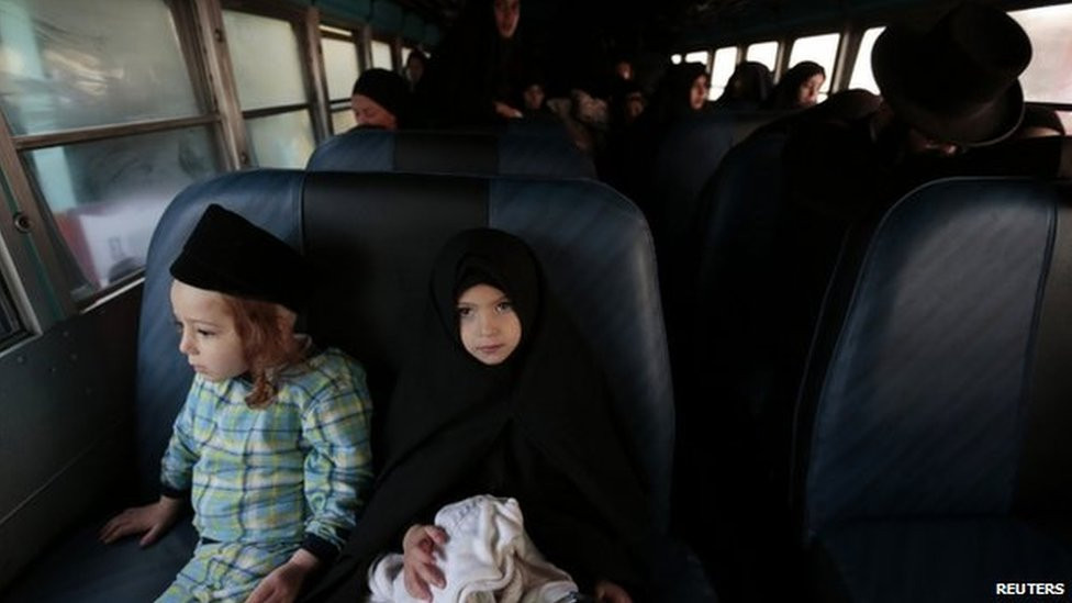 Lev Tahor members prepare to leave San Juan La Laguna on a bus