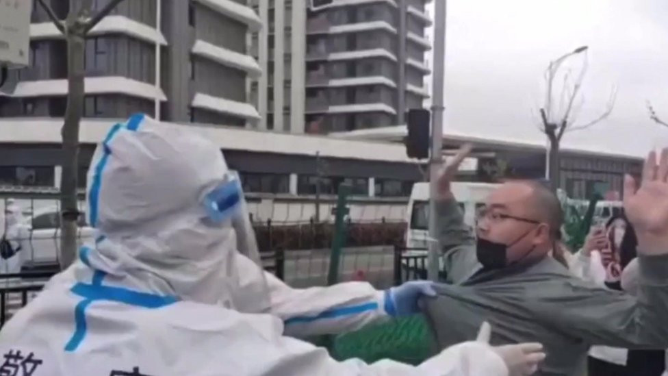 Shanghai police remove protester