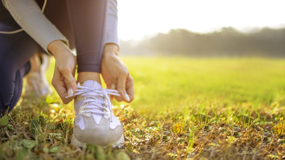 Runner tying her shoes