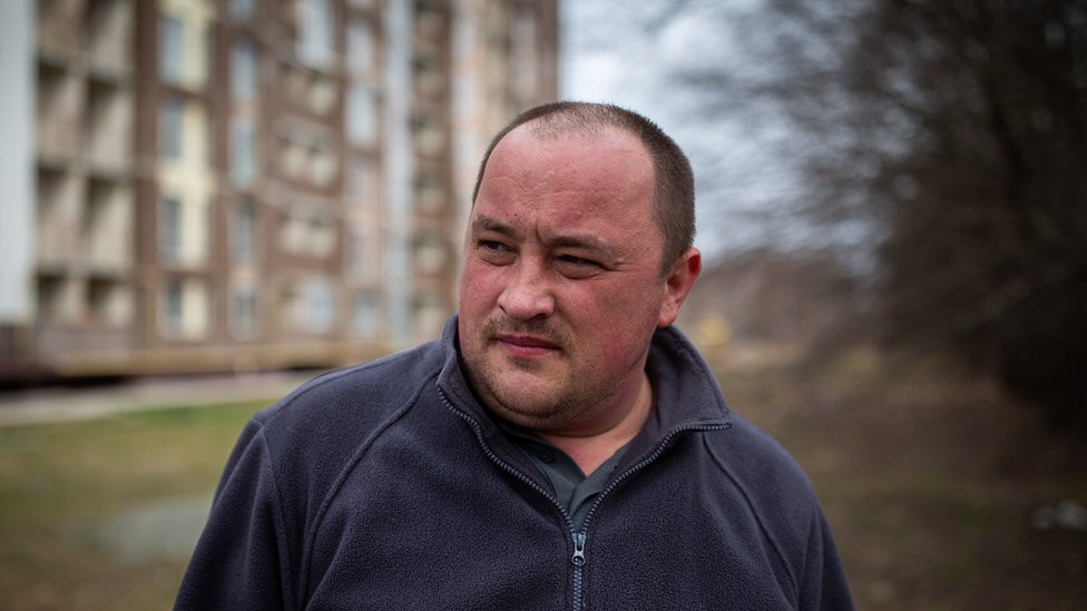 Serhiy Brezhnev stands over his brother's body. "He was a kind-hearted man, he gave his all," Serhiy said.