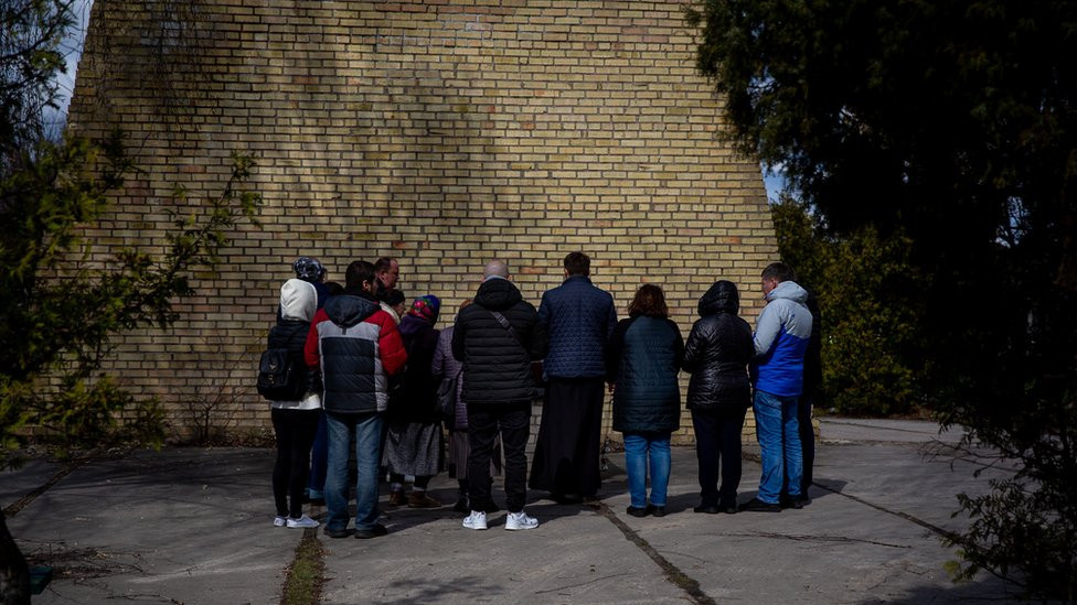 The family gathers for a small funeral service for Vitaliy