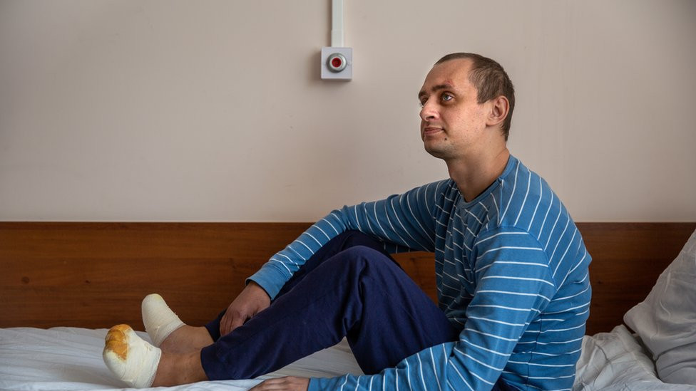 Nikita Horban sits on his hospital bed in Kyiv. He has begun to take a few steps.