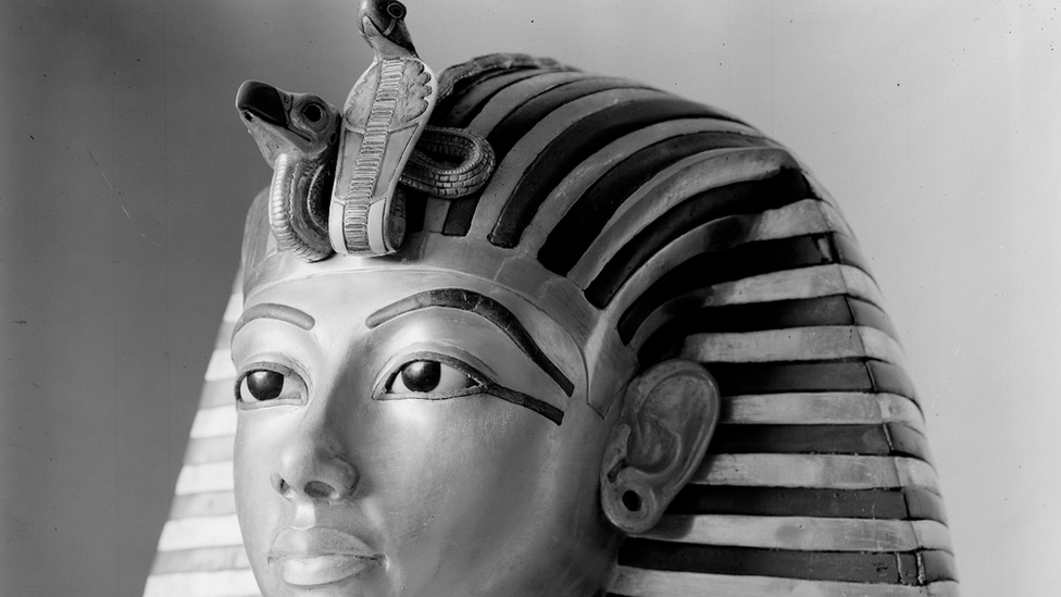 Tutankhamun's gold mask pictured on a stand during the conservation process