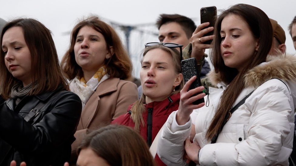 Fans sing along to Oleh's lyrics at a pop-up gig in Irpin