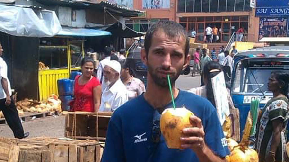 Volodymyr drinking from a coconut