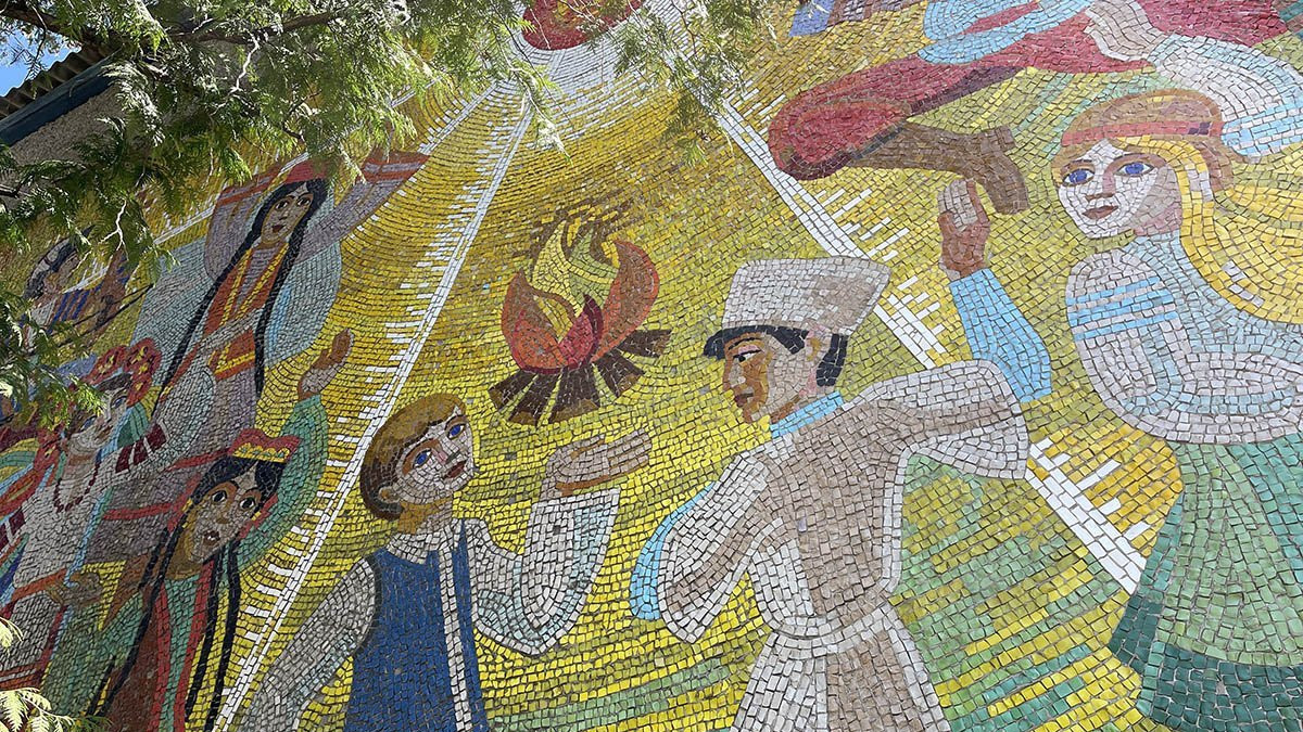 Mosaic of children dancing around a camp fire