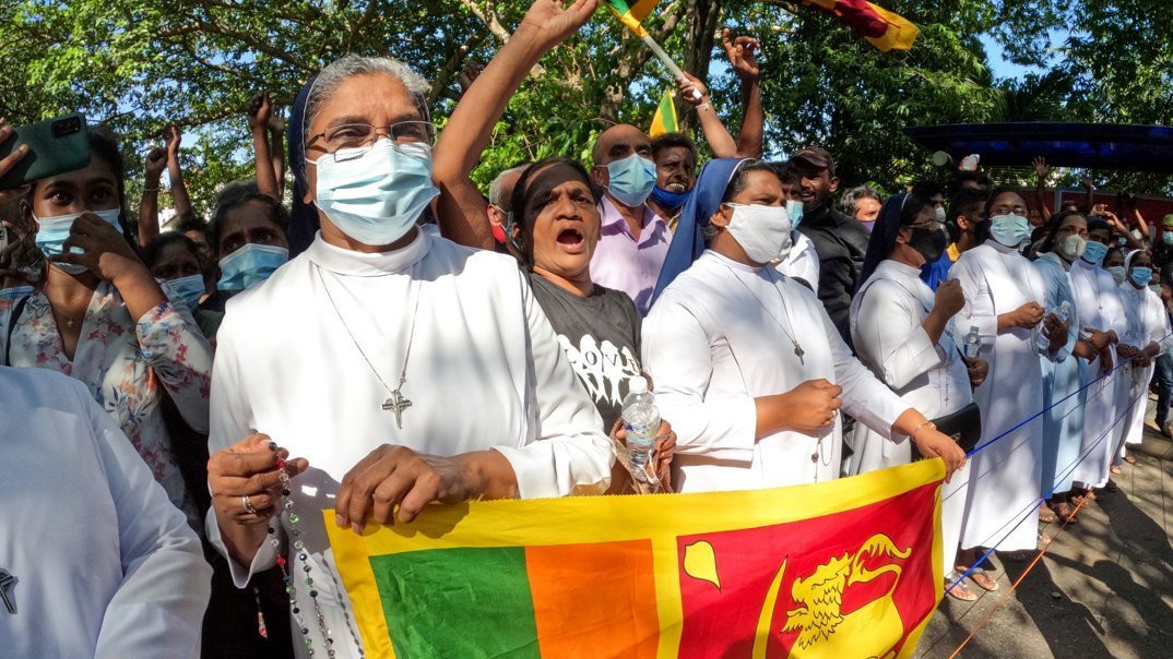 Sri Lankan catholic nuns shield protesters during a demonstration near the president's office in Colombo on 24 April 2022