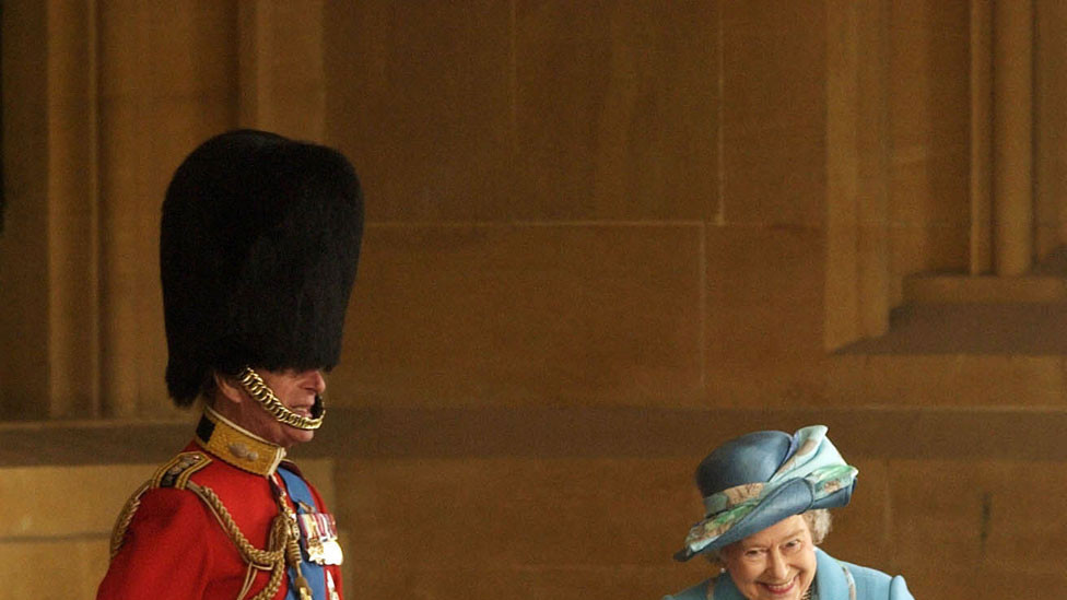 Prince Philip in Grenadier Guards uniform laughing with the Queen