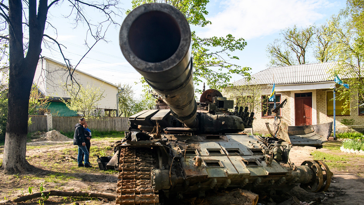 Local residents look at a destroyed Russian tank in Sloboda, Chernihiv, Ukraine - 8 May 2022