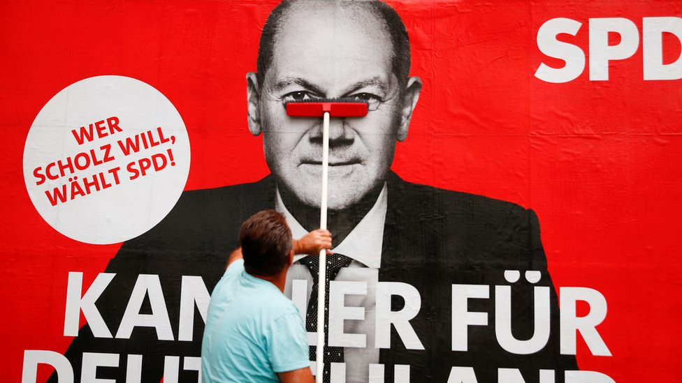 A placard of Olaf Scholz, candidate for Chancellor of Germany's Social Democratic party SPD is placed on a board for the September 26 German general elections in Bonn, Germany, September 20, 2021