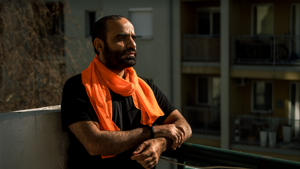 Mansoor Adayfi on the balcony of his Belgrade apartment. "Guantanamo follows you everywhere you go," he said.