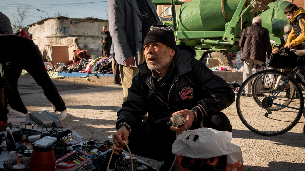 Zakir Hasam at the junk market near his home in Tirana. 'We have no ID, it interferes with every part of life," he said.