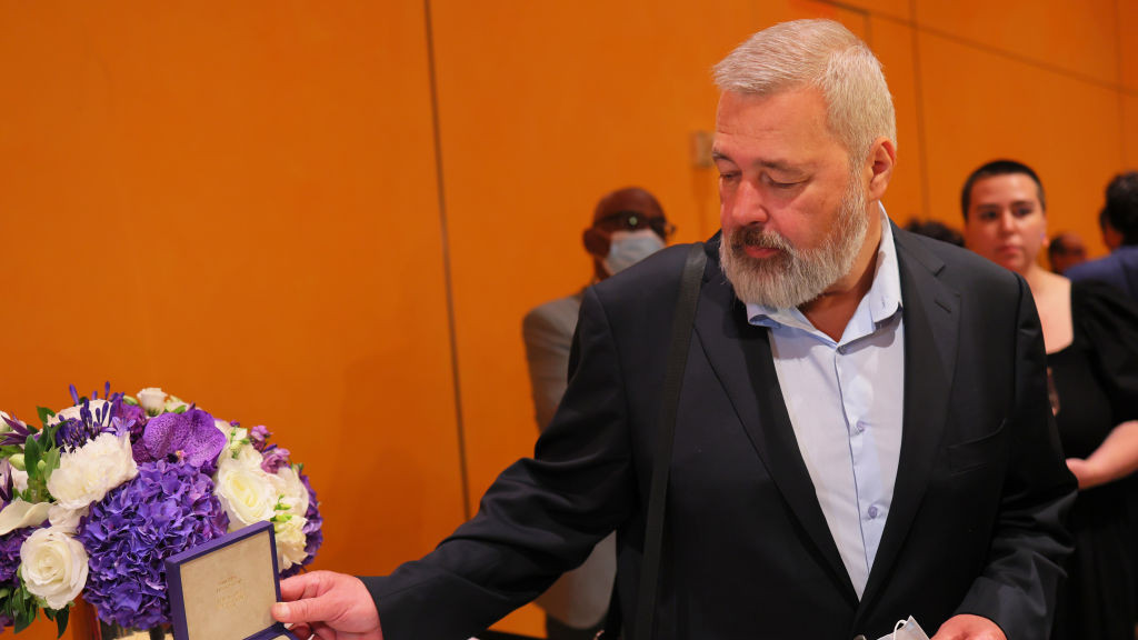 Dmitry Muratov poses with his 2021 Nobel Peace Prize at The Times Center on June 20, 2022 in New York City