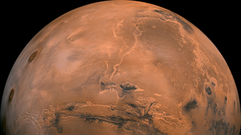 Mars, with dark ridges visible across the centre and to the right