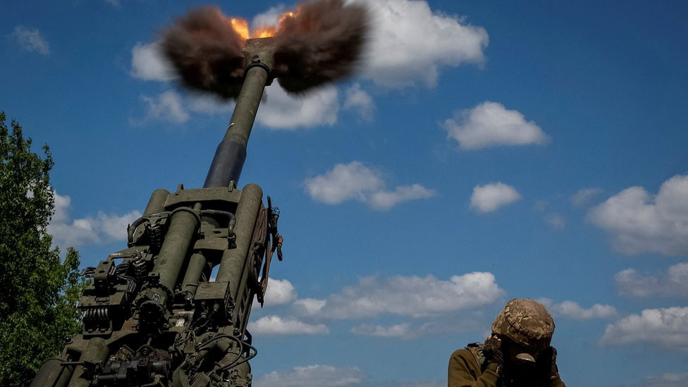Ukrainian soldiers fire a shell from a M777 Howitzer in Donetsk Region,