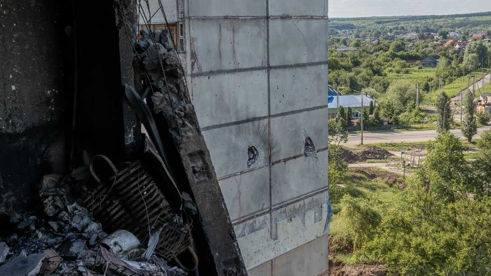The buildings are marked by distinctive holes from rockets and shells. Some contain unexploded ordnance