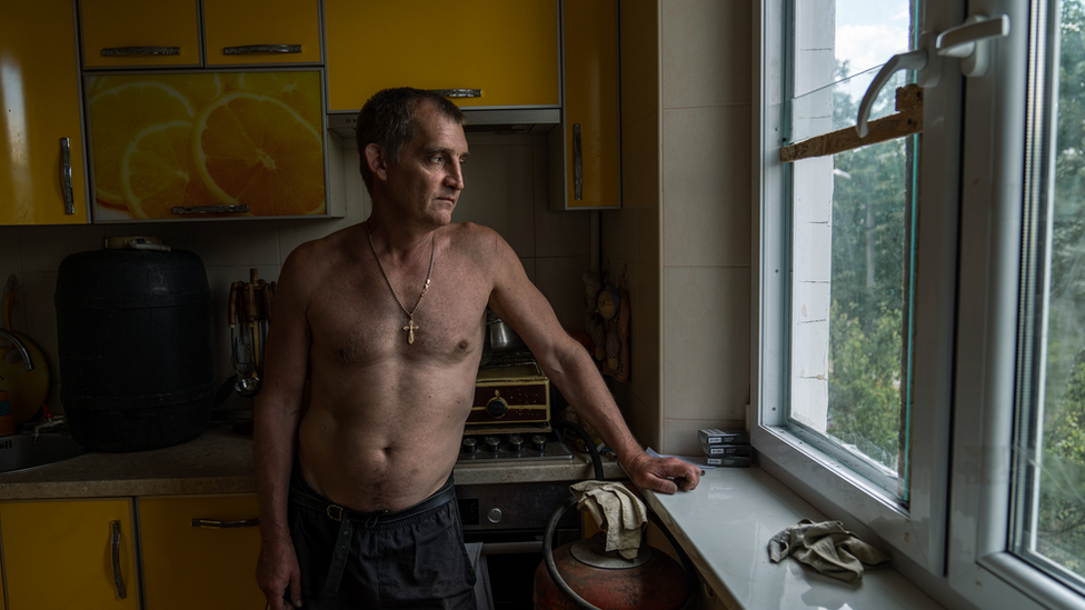 Roman Grynchenko's flat survived the shelling so far. Three floors above him are completely destroyed