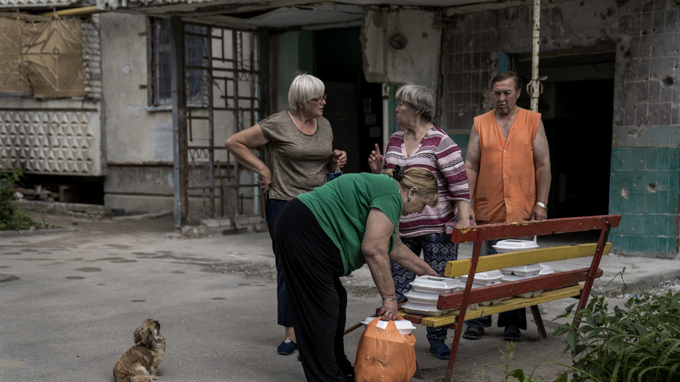 Saltivka residents collect free meals delivered once a day by a food charity. For many, it is there one meal a day now