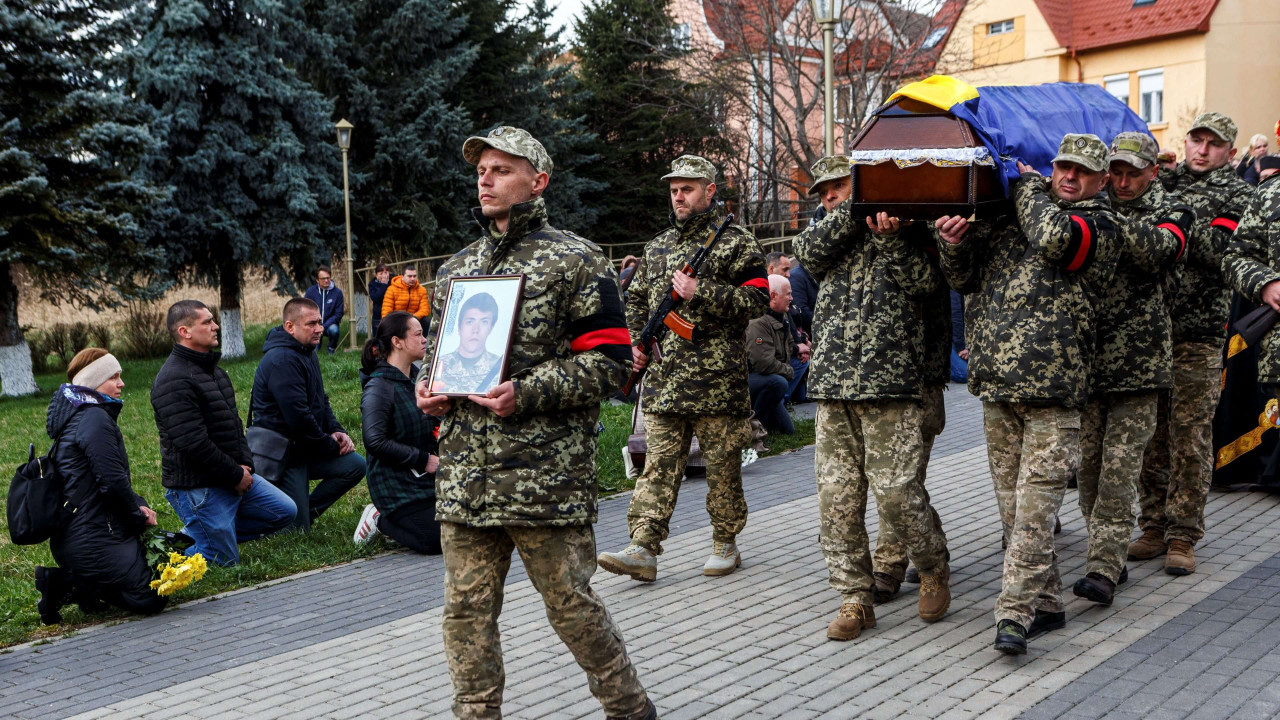 Photo of Ukrainian soldiers carrying the coffin of their fallen colleague, Sviatoslav Soyko, during his funeral in Uzhhorod, Ukraine. The young man died during the conflict with Russia.