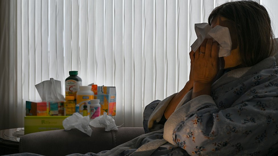 Woman blowing her nose